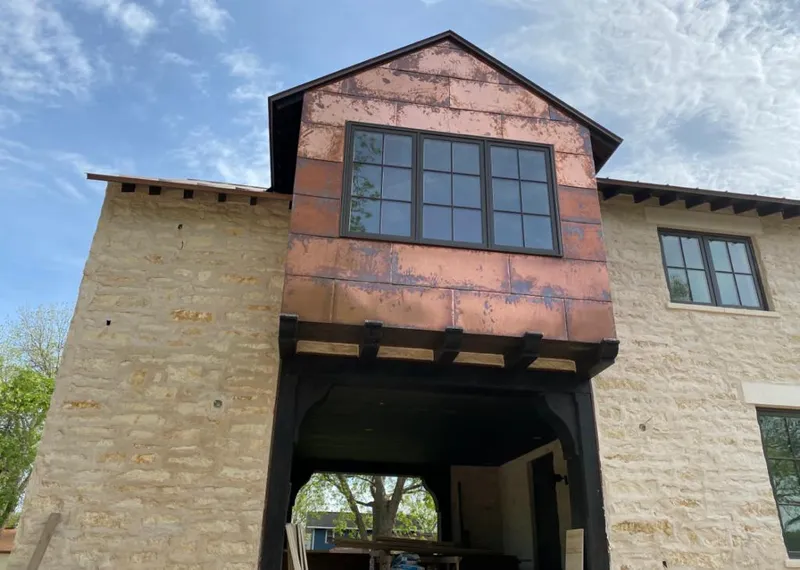 Copper metal panel facade on a stone building for Metal Roof Coating in Prior Lake